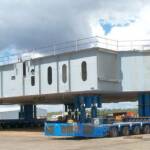 Self-propelled modular trailers (SPMTs) transporting a dragline assembly for the mining industry.